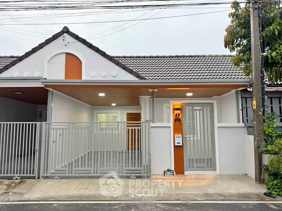 Charming single-story home with modern facade and gated entrance, perfect for families seeking comfort and security.