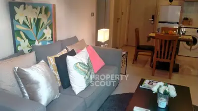 Stylish living room with modern decor and cozy seating in a contemporary apartment.