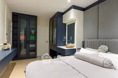 Modern bedroom with stylish decor and ample storage space, featuring a cozy bed and elegant furnishings.