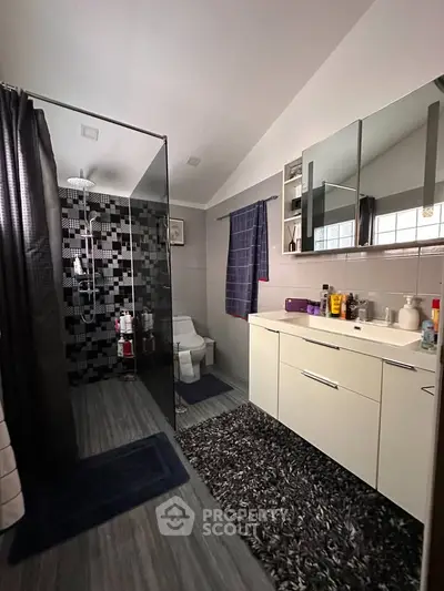 Modern bathroom with sleek shower, stylish vanity, and contemporary decor.