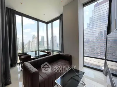 Luxurious corner unit with panoramic city views and modern furnishings in a high-rise building.