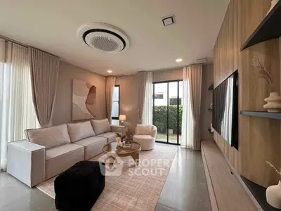 Modern living room with elegant decor, large windows, and stylish furniture in a contemporary home.