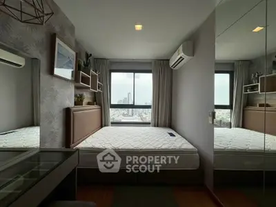 Modern bedroom with city view, featuring stylish decor and air conditioning, perfect for urban living.