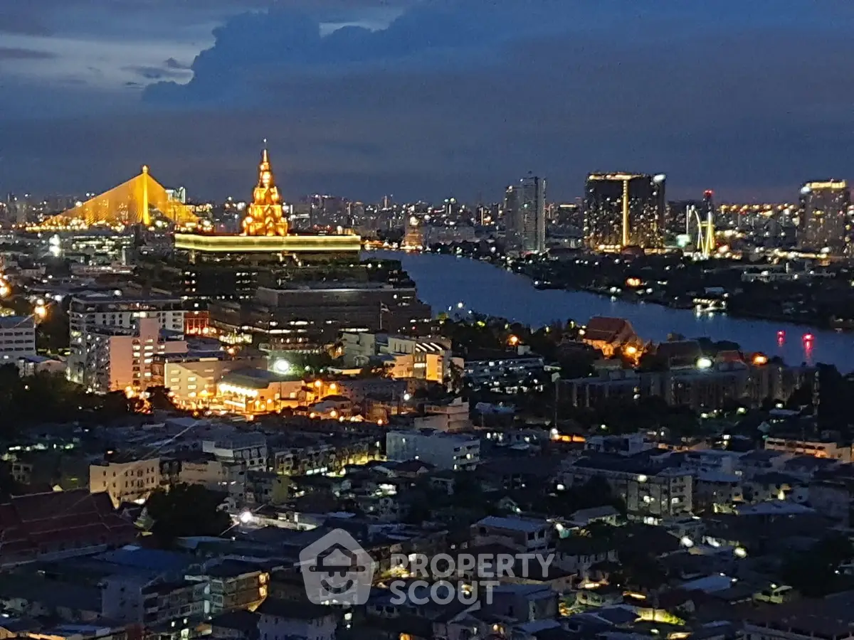 Stunning cityscape view with illuminated buildings and river at dusk, showcasing urban elegance.