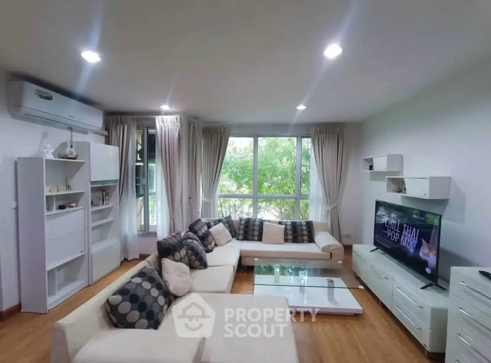 Spacious modern living room with large windows and stylish furniture