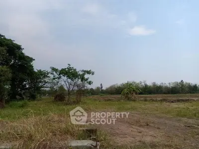 Expansive land plot with lush greenery and clear skies, ideal for development opportunities.