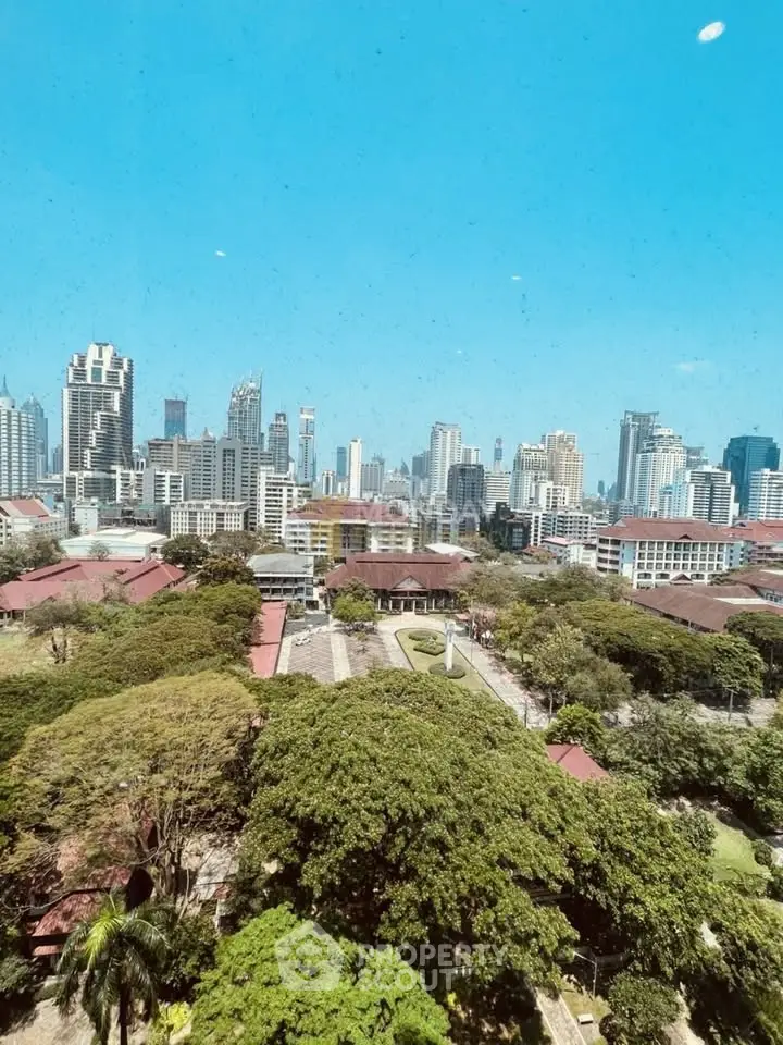 Stunning cityscape view showcasing urban skyline and lush greenery, perfect for real estate investment.