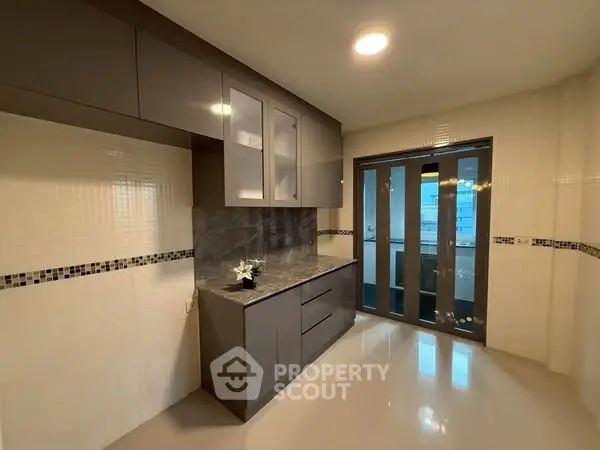 Modern kitchen with sleek cabinets and sliding glass doors