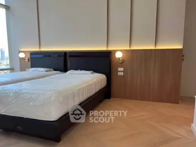 Modern bedroom with twin beds and stylish lighting in luxury apartment