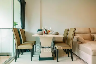Modern dining area with elegant table and chairs next to a cozy sofa, perfect for stylish living.