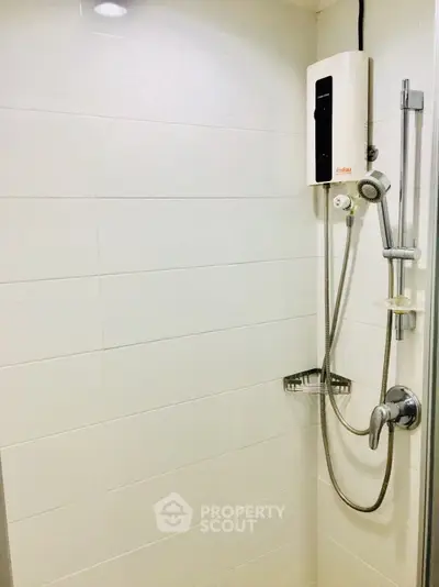Modern bathroom shower with sleek white tiles and water heater