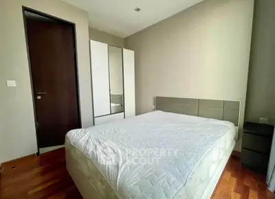 Modern bedroom with sleek design and wooden flooring