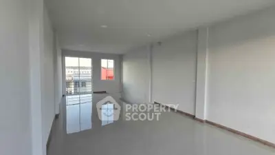 Spacious empty room with large windows and glossy tiled floor, perfect for customization.