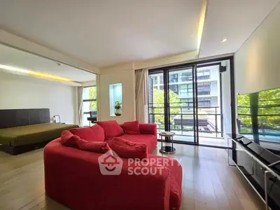 Spacious modern living room with red sofa and balcony view in luxury apartment