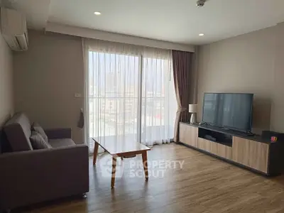 Modern living room with large window and stylish furniture