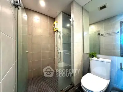 Modern bathroom with glass shower and sleek tile design