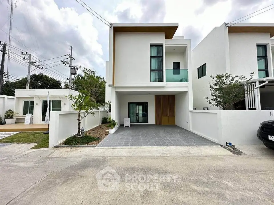Modern two-story white house with driveway and minimalist design
