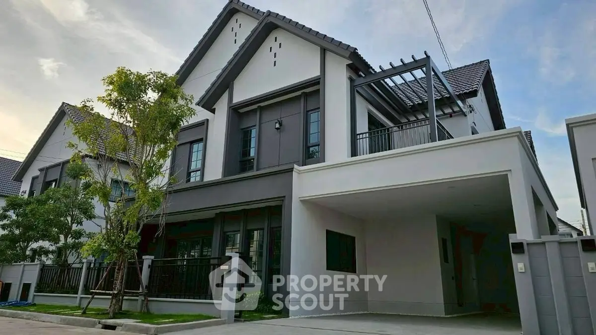 Modern two-story house with sleek design and spacious driveway in a serene neighborhood.