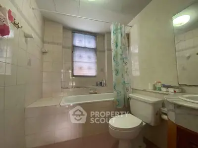 Cozy bathroom with bathtub and modern fixtures in a well-lit space.