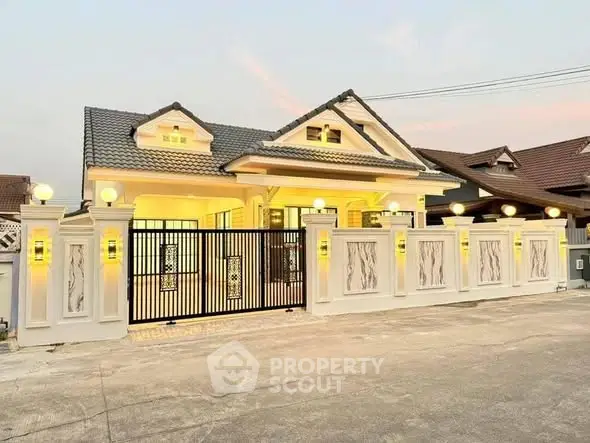 Charming single-story home with elegant lighting and gated entrance at dusk.