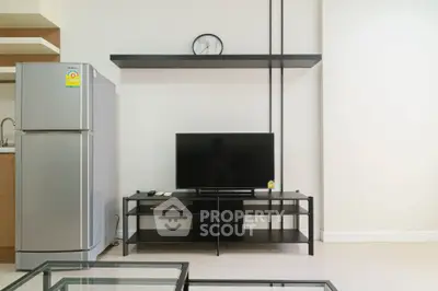 Modern living room with sleek TV stand and stainless steel fridge