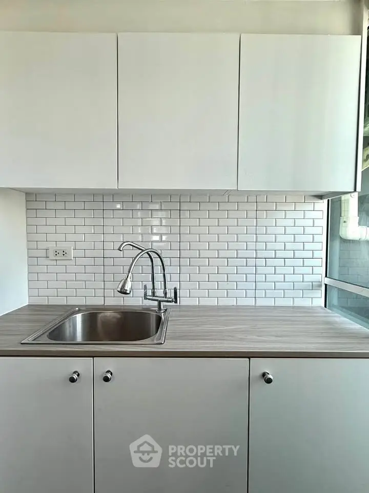 Modern kitchen with sleek cabinetry and subway tile backsplash