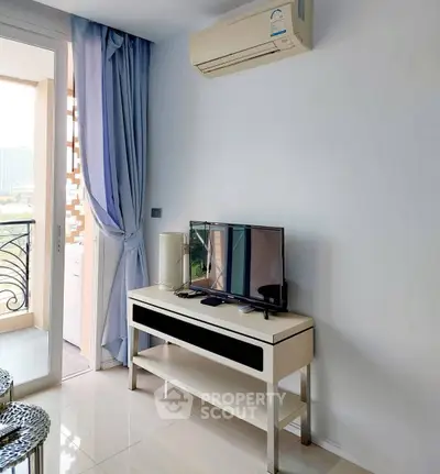 Modern living room with balcony access and air conditioning