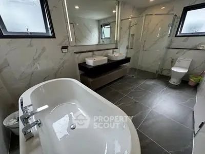 Luxurious modern bathroom with freestanding bathtub and dual sinks