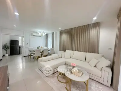 Spacious modern living room with elegant decor and open dining area