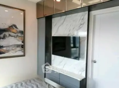 Modern bedroom with sleek TV setup and stylish decor