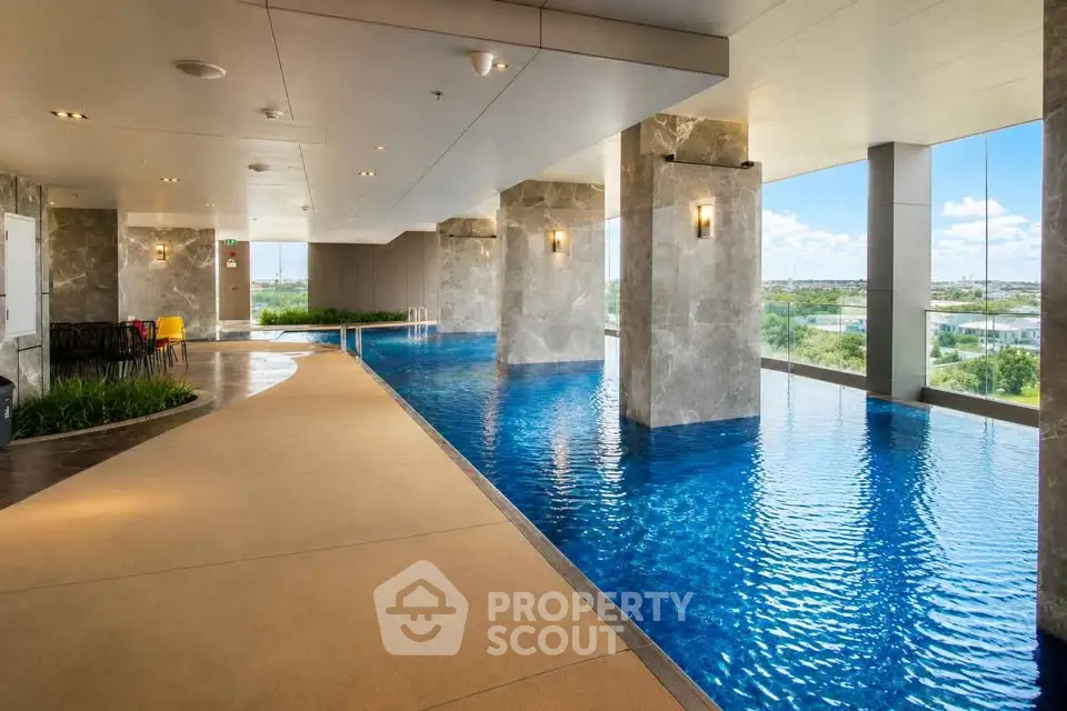 Luxurious indoor pool with panoramic views in modern high-rise building