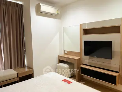 Modern bedroom with air conditioning and stylish wooden furniture, perfect for comfort and relaxation.