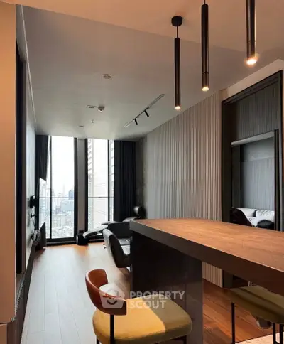 Modern living room with city view, sleek design, and stylish furniture in a high-rise apartment.