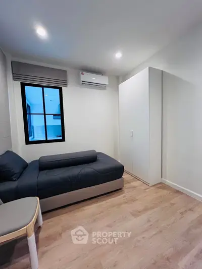 Cozy bedroom with modern furniture and air conditioning in a stylish apartment.