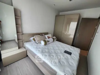 Modern bedroom with sleek design, featuring a comfortable bed and ample storage space.