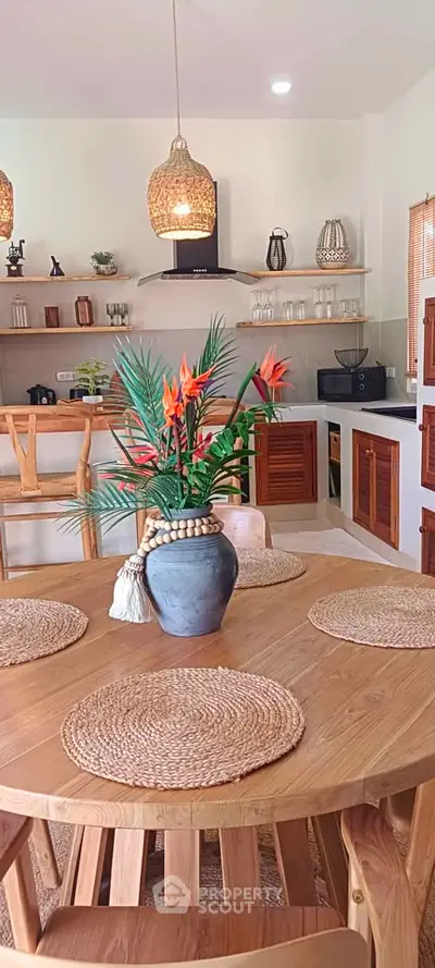 Charming kitchen with wooden dining set and modern decor, featuring open shelves and elegant lighting.