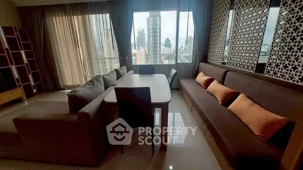 Spacious living room with modern decor and city view, featuring comfortable seating and elegant design.
