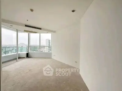 Spacious corner unit with large windows offering a stunning city view, perfect for modern living.