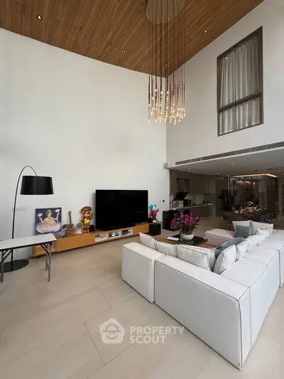 Luxurious modern living room with high ceiling and elegant chandelier