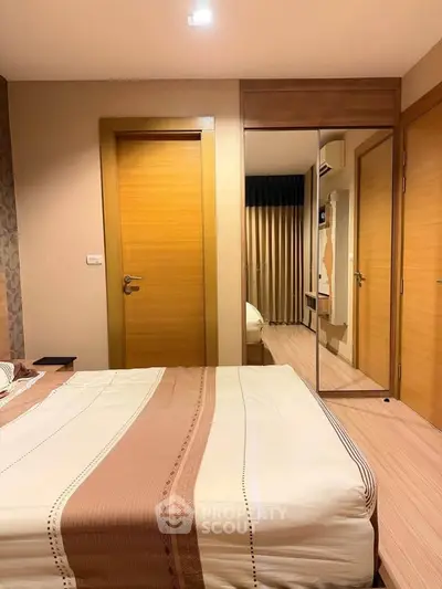 Modern bedroom with wooden accents and mirrored wardrobe