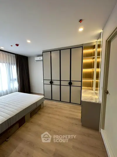 Modern bedroom with sleek wardrobe and natural light