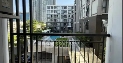 Modern apartment balcony with pool view in urban high-rise complex