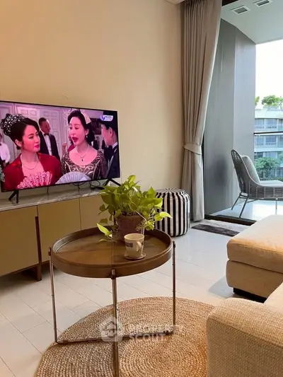 Cozy living room with modern decor and TV, perfect for relaxation.