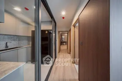 Sleek modern kitchen with closed layout and stylish cabinetry in a contemporary apartment.