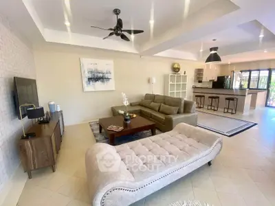 Spacious open-plan living room with modern decor and kitchen view