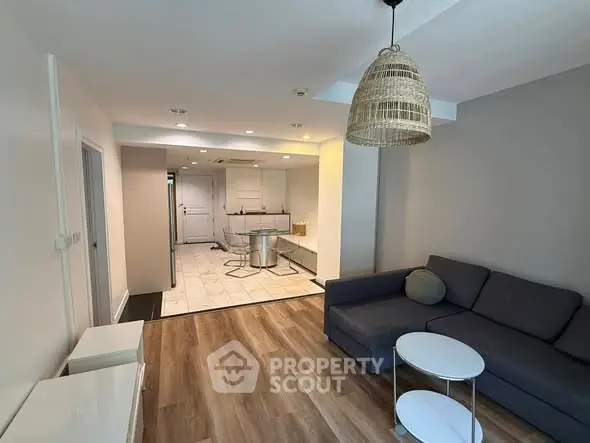 Modern open-plan living room with stylish decor and cozy seating area.