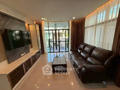 Spacious living room with modern decor and large windows offering natural light
