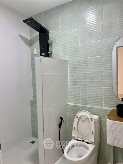 Modern bathroom with sleek shower and stylish vanity in contemporary home.