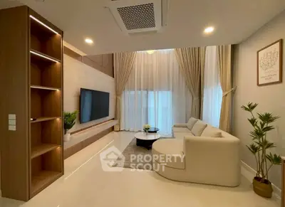 Luxurious modern living room with elegant decor and large windows.