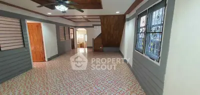 Spacious interior with unique tile flooring and wooden accents in a cozy home setting.